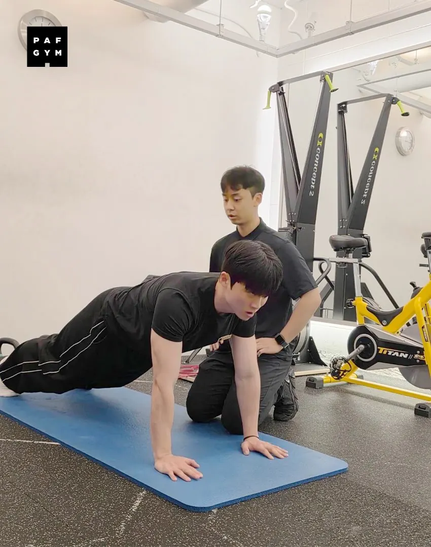 박진홍 트레이너 · 교육생의 버드독 자세를 지도하는 모습